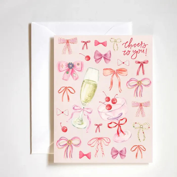 "Coquette Cheers Card" – Feminine A2 congratulations card with hand-drawn bows and luxe finish
"Bows & Congrats Card" – Girly celebration card featuring coquette-style artwork
"Cheers to You Stationery" – Playful and elegant card perfect for congratulating with style