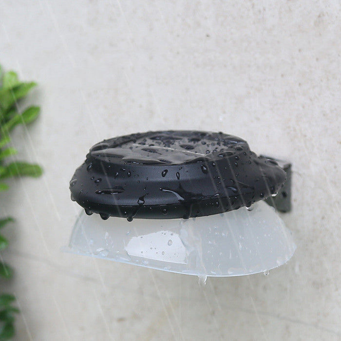 Modern outdoor fence wall lamp mounted on garden fence illuminating patio area