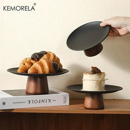Round acacia wood cake stand with a natural solid finish and footed base