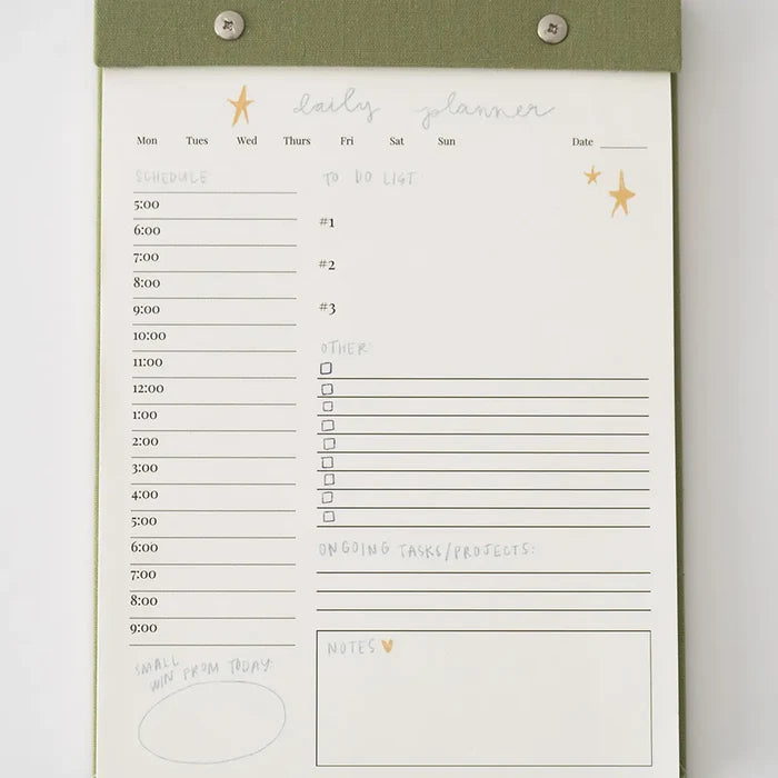 “Elegant Daily Planner Notepad” – Notepad with linen backing and silver hardware on a clean desk with pens

“Tear-Off Productivity Pad” – Page in use with to-do list filled in and planner accessories nearby