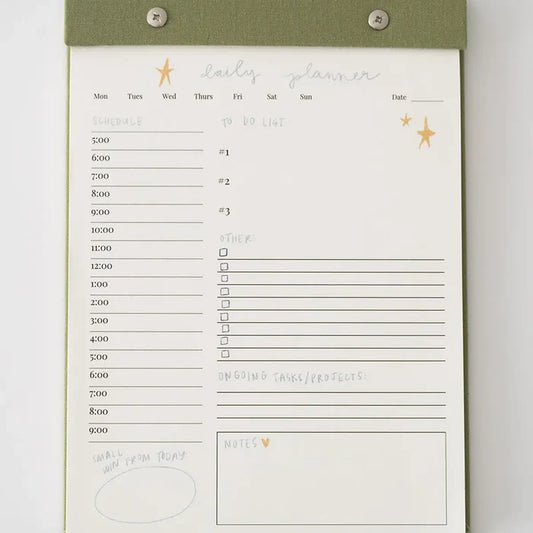 “Elegant Daily Planner Notepad” – Notepad with linen backing and silver hardware on a clean desk with pens

“Tear-Off Productivity Pad” – Page in use with to-do list filled in and planner accessories nearby