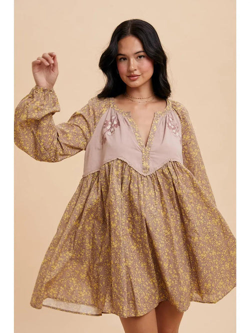 Woman wearing a floral dress with a beige background