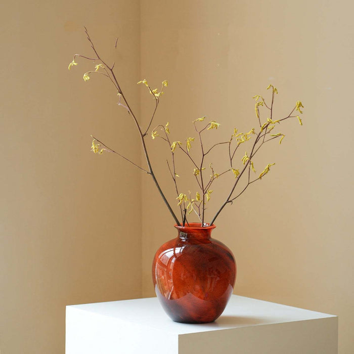 Clear lustrous glass vase with smooth finish and wide opening for flowers
