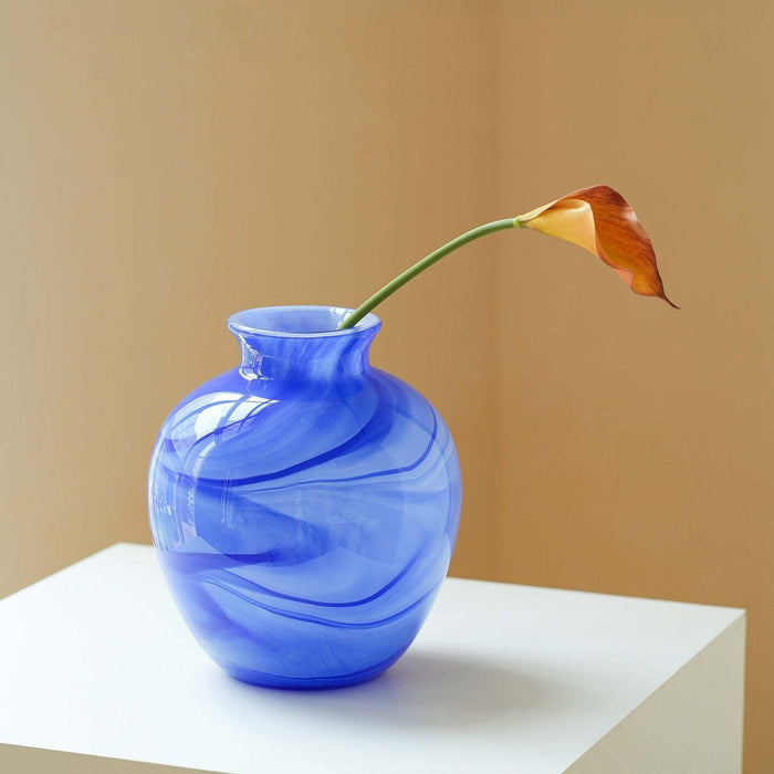 Clear lustrous glass vase with smooth finish and wide opening for floral arrangements