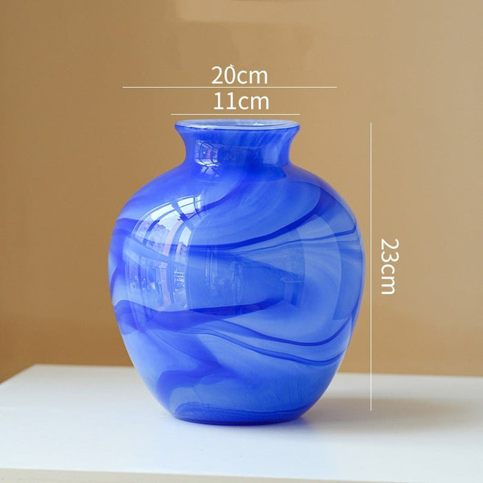 Clear lustrous glass vase with smooth finish and wide opening for floral arrangements
