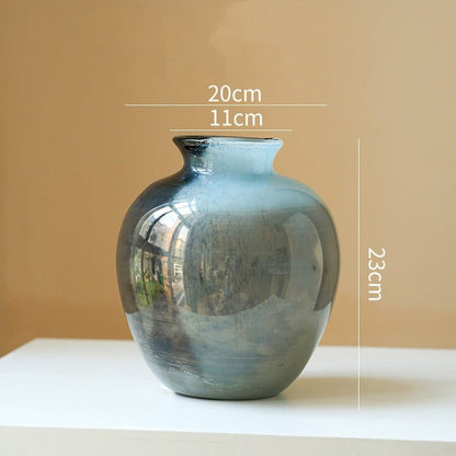 Clear lustrous glass vase with smooth finish and wide opening for floral arrangements