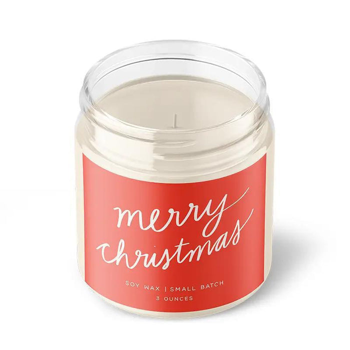 “Small amber jar candle labeled MERRY CHRISTMAS surrounded by ornaments and festive greenery.”

“Hand-poured soy candle burning beside wrapped gifts and holiday décor.”

“Flat lay of MERRY CHRISTMAS candle with pinecones, cinnamon sticks, and twinkle lights.”