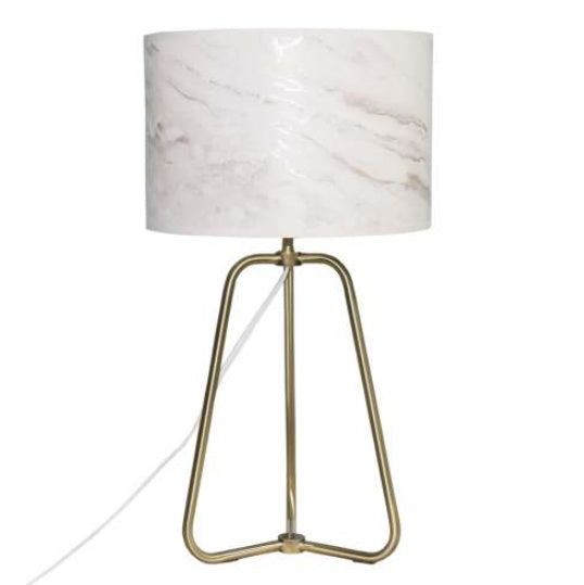 Small modern stylish desk lamp with marble-patterned shade and bronze base on table