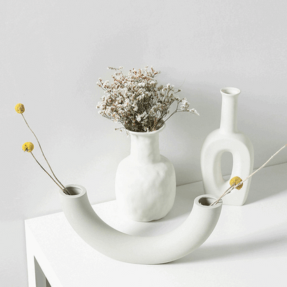 Minimalist Nordic decoration ceramic vase with matte glaze on wooden table in modern interior