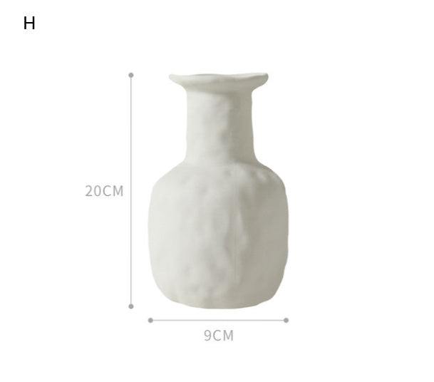Minimalist Nordic decoration ceramic vase with matte glaze on wooden table in modern interior