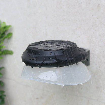 Modern outdoor fence wall lamp mounted on garden fence illuminating patio area