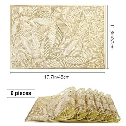 Golden rectangle table mat with hollow leaf design made of PVC and vinyl on a dining table