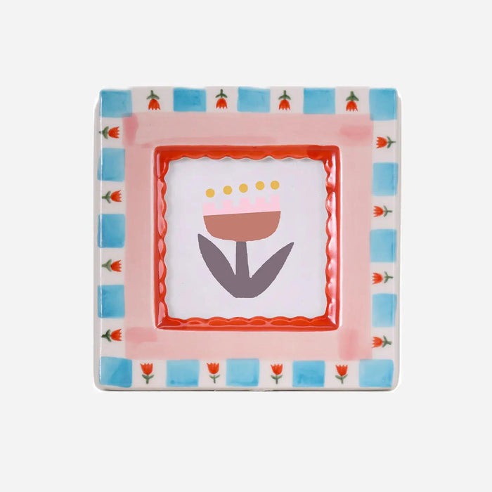 “Hand-painted ceramic photo frame with red flower patterns on a white base.”

“Close-up of a red floral ceramic frame holding a small photograph on a wooden table.”

“Decorative red flower photo frame surrounded by petals and soft light.”