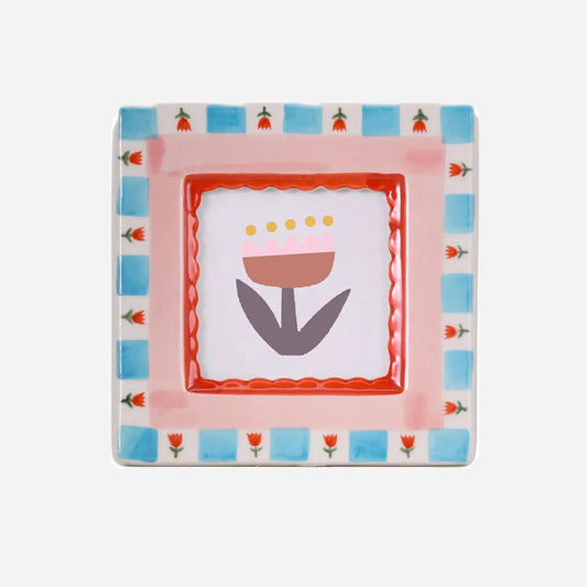 “Hand-painted ceramic photo frame with red flower patterns on a white base.”

“Close-up of a red floral ceramic frame holding a small photograph on a wooden table.”

“Decorative red flower photo frame surrounded by petals and soft light.”