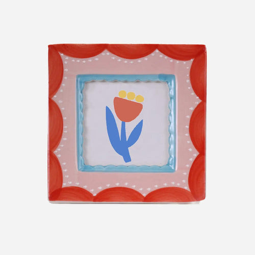 “Square hand-painted ceramic photo frame featuring red scalloped patterns on a white base.”

“Close-up of a red scallop ceramic frame displaying a small photo on a neutral background.”

“Hand-painted red and white scallop photo frame styled on a desk beside flowers and candles.”