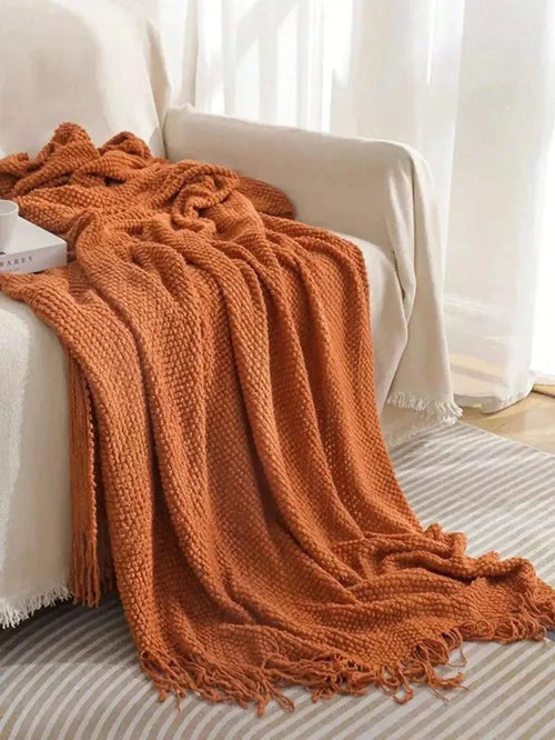 Soft textured knit throw blanket folded on sofa for cozy home decor